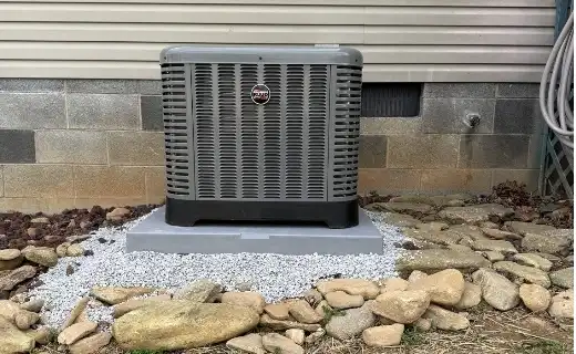 Newly installed residential air conditioning condenser on a gravel pad in Hickory NC