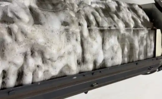 Foam cleaning treatment on an evaporator coil during an HVAC maintenance visit